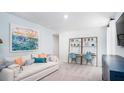 Cozy living room with a comfortable sofa, desk, shelving, and artwork, creating a relaxed and functional space at 325 Pine Crest View, Summerville, SC 29486