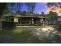 Rustic home with a cozy, inviting backyard setting with a fireplace and a covered porch with hammock at 3389 Prices Bridge Ln, Walterboro, SC 29488