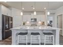 Modern kitchen with white cabinets, quartz countertops, stainless steel appliances, and a breakfast bar with seating at 349 Long Pier St, Summerville, SC 29486