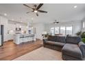 Spacious open-concept living area with wood floors, ceiling fans, and a seamless flow to the kitchen and dining area at 349 Long Pier St, Summerville, SC 29486