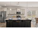 Modern kitchen with a large center island, granite countertops, and stainless steel appliances at 433 Thoroughbred Dr, Moncks Corner, SC 29461