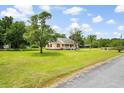 Lovely home features a well-kept lawn and mature trees that offer shade and privacy at 449 Mary Lou Ln, Moncks Corner, SC 29461