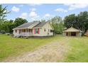 Well-maintained home boasts a detached garage and a spacious yard perfect for outdoor activities at 449 Mary Lou Ln, Moncks Corner, SC 29461