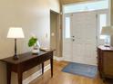 Bright entryway with hardwood floors and a view of the white front door and sidelights at 462 Maple Oak Ln, Charleston, SC 29414