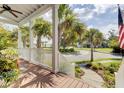 Front porch view showcasing a charming neighborhood with palm trees, lush landscaping, and inviting curb appeal at 509 Gilberts Lndg, Mount Pleasant, SC 29464