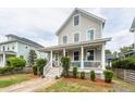 Charming two-story home featuring a welcoming front porch with classic white columns and a neatly landscaped yard at 5153 Celtic Dr, North Charleston, SC 29405