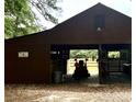 View of the barn, revealing space for equipment and a well-maintained interior at 5354 Ceva Dr, Hollywood, SC 29449