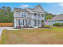 Charming two-story home with a double porch, driveway and mature landscaping at 5497 Alpine Dr, Summerville, SC 29483