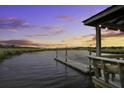 Picturesque waterfront view from a private dock at sunset with beautiful orange and blue skies at 5911 Steward St # 24, Hanahan, SC 29410