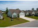 Well-maintained home with a spacious driveway, two-car garage and manicured front lawn at 6176 Wilkes Pond Dr, Hollywood, SC 29449