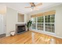 Open living room features hardwood floors, fireplace, ceiling fan, and natural light at 700 Daniel Ellis Dr # 4104, Charleston, SC 29412