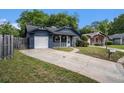 Charming blue home with a white porch, attached garage, and wide driveway at 8268 Timberidge Ct, North Charleston, SC 29420