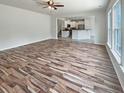 Spacious living room featuring new hardwood floors, abundant natural light and open layout to the kitchen at 982 Augustine Ct, Summerville, SC 29483