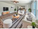 Comfortable living room featuring a fireplace, modern furniture, hardwood floors, and open layout to the kitchen at 982 Augustine Ct, Summerville, SC 29483