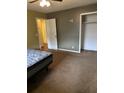 View of a bedroom with brown carpet, closet, open door and bed frame at 10 Cranford Rd, Goose Creek, SC 29445