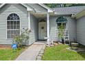 Inviting front entrance with arched windows, and stone pathway at 102 Amberside Dr, Goose Creek, SC 29445