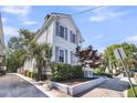 Side view of a charming two-story home with a well-manicured lawn at 103 Fishburne St, Charleston, SC 29403