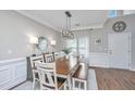 Bright dining room featuring a large table, modern lighting, and elegant trim at 107 Tandil Ct, Summerville, SC 29483