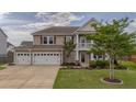 Beautiful two-story home featuring a three-car garage and well-kept lawn at 110 Ricewood Ln, Moncks Corner, SC 29461