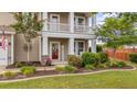Inviting front porch with decorative columns, landscaping, and 'HELLO' sign at 110 Ricewood Ln, Moncks Corner, SC 29461