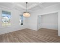 Dining room with wood-look flooring, a modern chandelier, and large windows at 111 Sawlog Dr, Summerville, SC 29486
