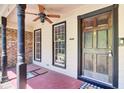 Inviting front porch with decorative columns, a ceiling fan, and a charming wooden front door at 113 Dove Ln, Summerville, SC 29485