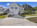 Traditional home with a two-car garage, mature landscaping, and a classic, covered front porch at 1166 Turkey Trot Dr, Johns Island, SC 29455