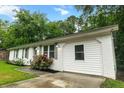 Charming white brick home features a well-maintained lawn, attached garage, and inviting curb appeal at 120 Lisa Dr, Summerville, SC 29485