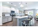 Modern kitchen with stainless steel appliances, marble countertops, and a breakfast bar at 121 Royal Cainhoy Way, Huger, SC 29450