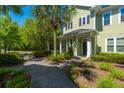 Charming home exterior with a quaint porch, lovely landscaping, and a welcoming walkway at 1225 Blakeway St # 1401, Charleston, SC 29492