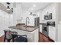 Inviting kitchen with a breakfast bar and stainless steel appliances at 1300 Park West Blvd # 215, Mount Pleasant, SC 29466