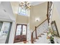 Elegant foyer featuring a grand staircase, soaring ceilings, and decorative lighting, creating a welcoming entrance at 1305 Old Rice Mill Rd, Moncks Corner, SC 29461