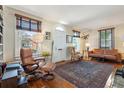 Cozy living room with hardwood floors, a decorative rug, large windows, and comfortable seating arrangements at 135 Beaufain St, Charleston, SC 29401
