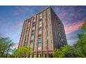 Striking exterior elevation of a high-rise apartment building with brick facade, set against a dramatic sky at 14 Lockwood Dr # 9K, Charleston, SC 29401