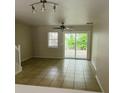 Open living area with tile floors, fan, and sliding door access to the outdoors at 145 Taylor Cir, Goose Creek, SC 29445