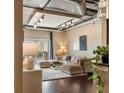 Inviting living room featuring an exposed ceiling, a neutral sectional sofa, and a private balcony with natural light at 150 Bee St # 507, Charleston, SC 29401