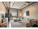 Inviting living room featuring an exposed ceiling, a neutral sectional sofa, and a private balcony with natural light at 150 Bee St # 507, Charleston, SC 29401