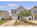 Charming two-story home with gray siding, well-manicured lawn, and an attached one car garage at 152 Kirkland St, Goose Creek, SC 29445