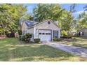 Home exterior view with garage and driveway, showcasing landscaping at 153 Corsair St, Summerville, SC 29483