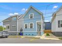 Charming blue two-story home with well-maintained landscaping and a cozy front porch at 169 Jackson St, Charleston, SC 29403