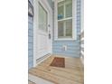 Close-up of front door area with welcome mat on cozy wooden porch at 169 Jackson St, Charleston, SC 29403