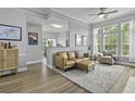 Bright living room featuring a ceiling fan, multiple windows, and an open concept at 1735 Telfair Way, Charleston, SC 29412
