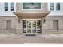 Charming brick building entrance with glass doors and transom windows, under an awning at 200 River Landing Dr # D310, Charleston, SC 29492