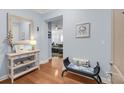 Inviting entryway featuring a wooden console table with decor, a mirror, and a bench at 200 River Landing Dr # D310, Charleston, SC 29492