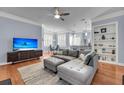 Comfortable living room features a large sofa, TV, hardwood floors, and open access to dining at 200 River Landing Dr # D310, Charleston, SC 29492