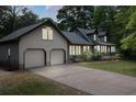 Inviting home featuring an attached two-car garage and a spacious driveway for ample parking at 2144 Pinopolis Rd, Pinopolis, SC 29469