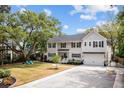 Charming two-story home featuring a well-maintained lawn and traditional architectural details at 2159 Parkway Dr, Charleston, SC 29412