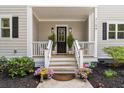 Inviting front porch with a decorative door and potted flowers at 2159 Parkway Dr, Charleston, SC 29412