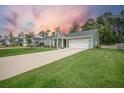 Well-kept home featuring an attached two-car garage and spacious driveway at 221 Lucca Dr, Summerville, SC 29486