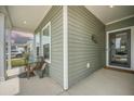 Cozy front porch area with a comfortable bench, stylish décor, and welcoming entrance at 221 Lucca Dr, Summerville, SC 29486